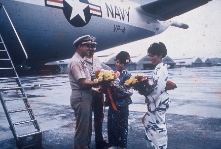 CAPT Walker on flightline with O Club waitresses